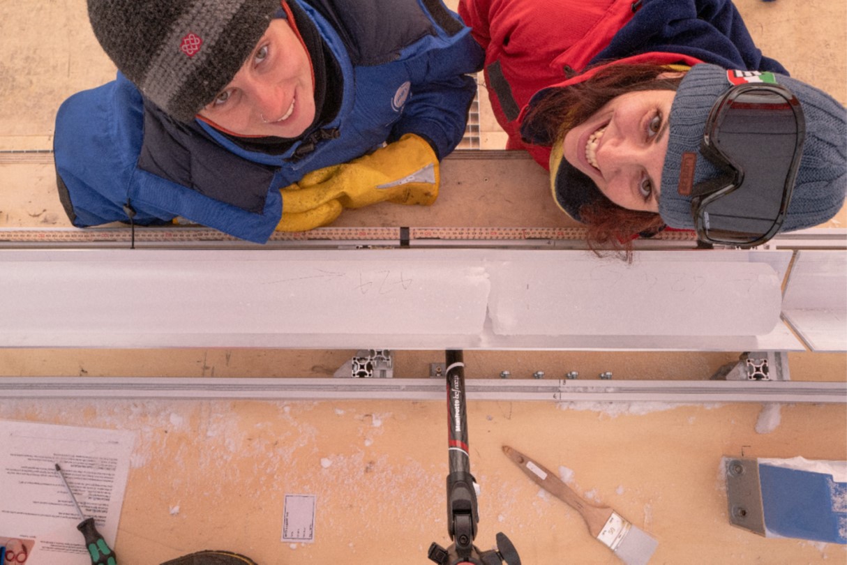 Giuditta (right) and Romilly (left) with bag number 424 on the cutting bench. The break in the ice is the join between two runs of the drill.